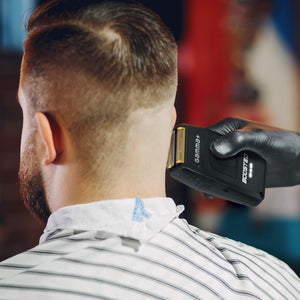 Person getting a haircut with a hair Boosted Professional Foil Shaver
in a barbershop setting