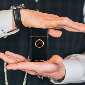 Barber holding Gamma+ Uno single foil shaver.