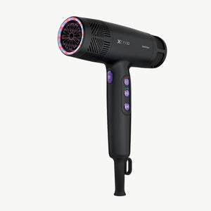 A black X-Ceed hair dryer with purple buttons and a pink/red illuminated nozzle, shown against a plain white background with stylized pink airflow lines.