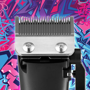 Close-up of homie nano hair clipper head with metal guide teeth, shown against a colorful graffiti-style background.