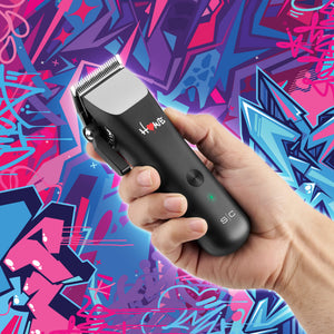 A hand holding homie nano hair clipper against a vibrant, colorful graffiti background. The clipper features the brand name 'HOME'. Showing size reference in hand