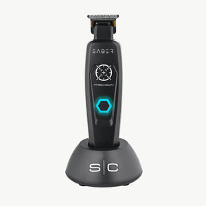 A black SABER Precision cordless electric trimmer standing upright on its matching black charging base against a white background.