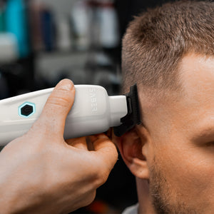 White Saber Trimmer with Digital Brushless Motor in barber's hand cutting hair