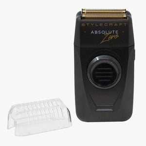 Stylecraft Absolute Zero electric shaver in black with gold trim, shown next to a clear protective cover on a white background.