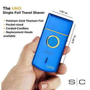 A hand holding a blue uno single-foil travel shaver with gold trim and a gold circular button. The image includes text describing the product features and dimensions, with the brand name 'uno' visible on the device.