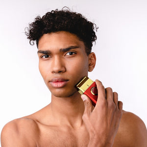 Man holding uno professional single foil shaver near his face against a white background