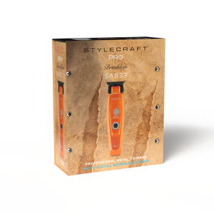 A boxed trimmer product on a plain white background. The box is tan and textured, with a large photo of an orange and black Stylecraft Pro Trimmer SAB-3 on the front.