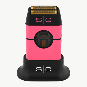 Instinct Metal Professional Double Foil Shaver with a gold-toned blade, shown upright on a matching black charging dock against a white background. The brand 's|c' is visible on both the shaver and the dock.