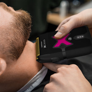 Person using a hair trimmer with Xceed branding on a blurred background