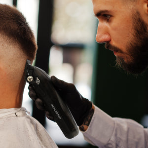Barber using black Instinct Metal Professional Hair Clipper with I N 2 Vector Motor