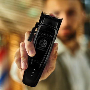 Black metal Saber 2 digital brushless clipper held by man out of focus.