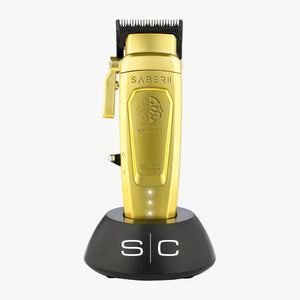 Gold metal Saber 2 digital brushless clipper in charging base