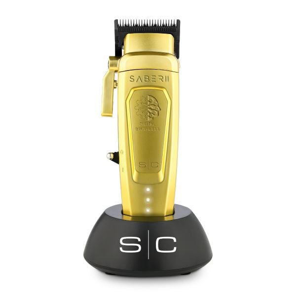 Gold metal Saber 2 digital brushless clipper in charging base