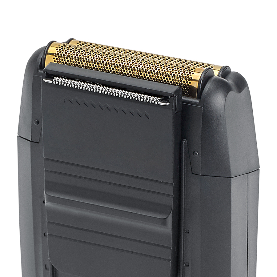 Image of the trimmer in black and gold in charging stands